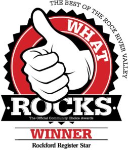 A graphic showing a thumbs-up icon with the text "WHAT ROCKS" and "WINNER" underneath. It indicates an award from the Rockford Register Star for the best in the Rock River Valley.
