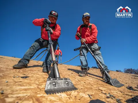Martin Exteriors roofers tearing off old shingles down to the roof deck | Martin Exteriors