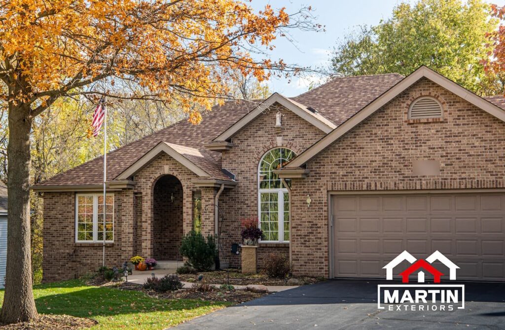 Brown shingle roof by Martin Exteriors on a brick ranch home with an arched front entry