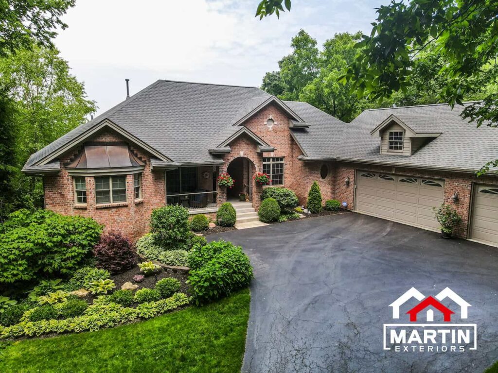 Shingle roof by Martin Exteriors on a brick home with a dormer over the garage