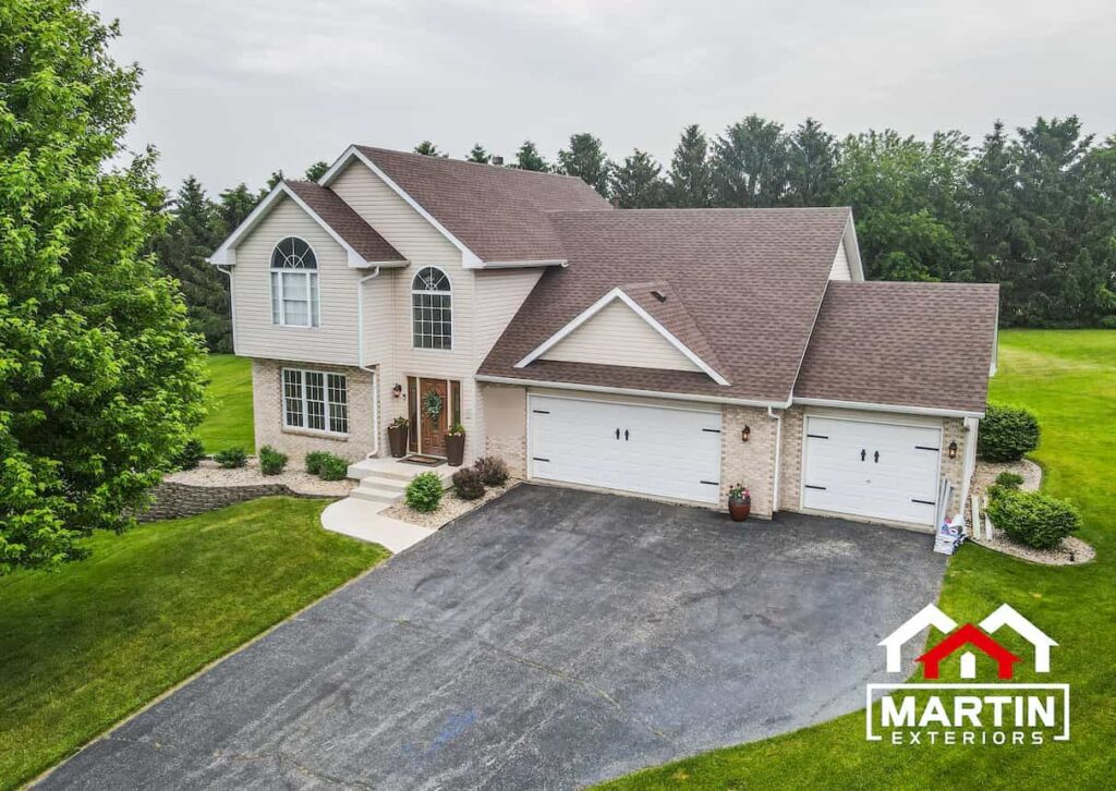 Brown shingle roof by Martin Exteriors on a two-story home with two garages, seen from above