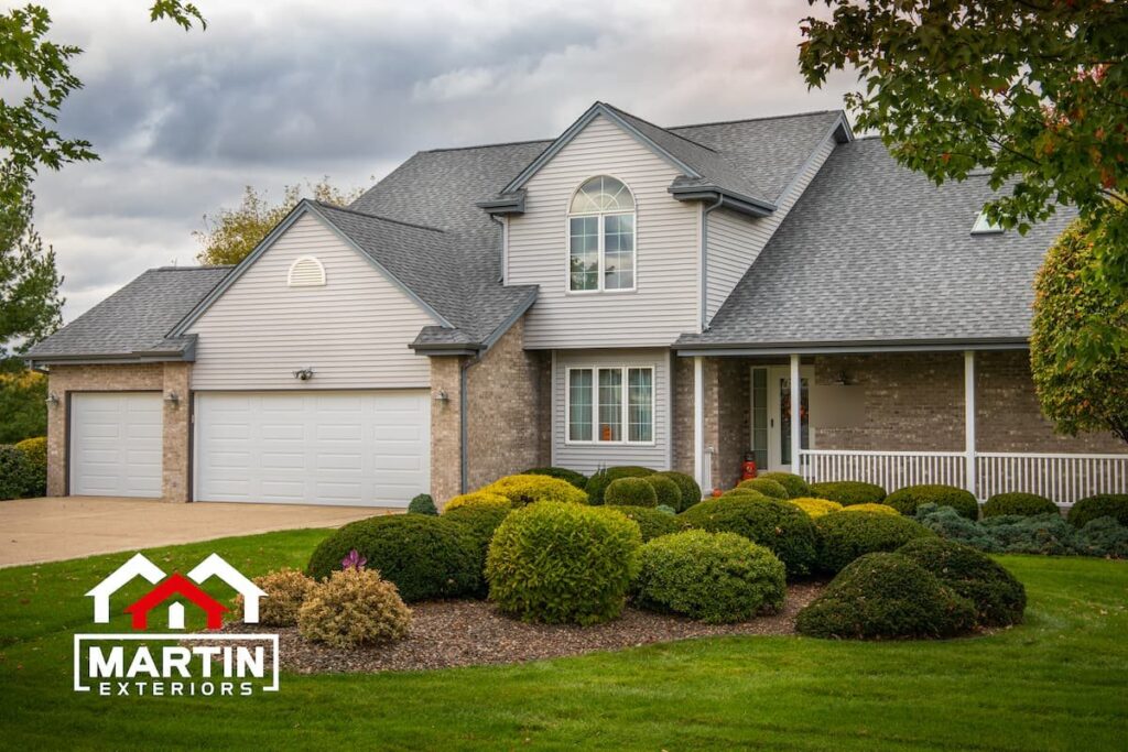 Gray architectural shingle roof by Martin Exteriors on a two-story home with a three-car garage