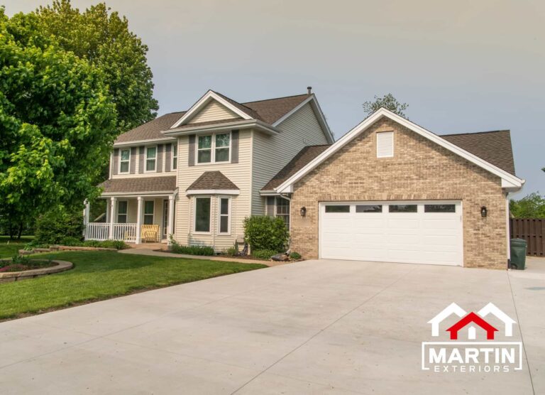 Rockford-area roof replacement by Martin Exteriors on a two-story home with a stone front and wide garage