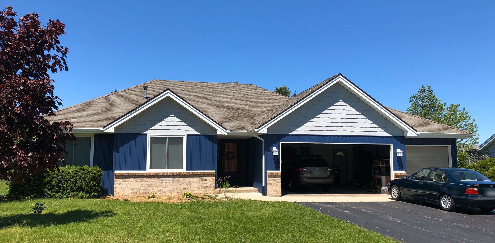 Rockford-area siding project by Martin Exteriors, blue siding and white trim on a ranch home