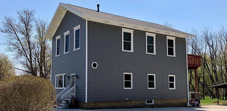 Rockford-area siding replacement by Martin Exteriors, gray lap siding on a two-story home