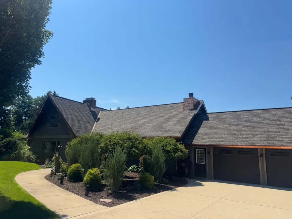 Muted gray brown designer shingle roof on a gabled home with dark siding in Rockton, IL